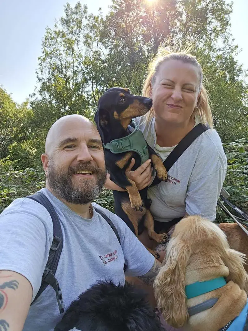 Happy doggy parents with their dachshund at Carols Canine Caring Bursledon